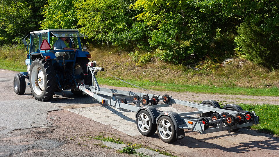 Boat trailer being backed down boat ramp